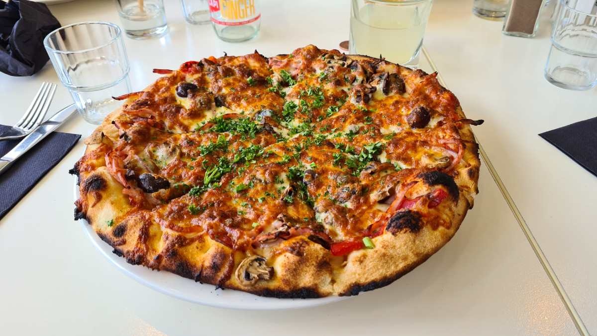 pizza atop white plate and table