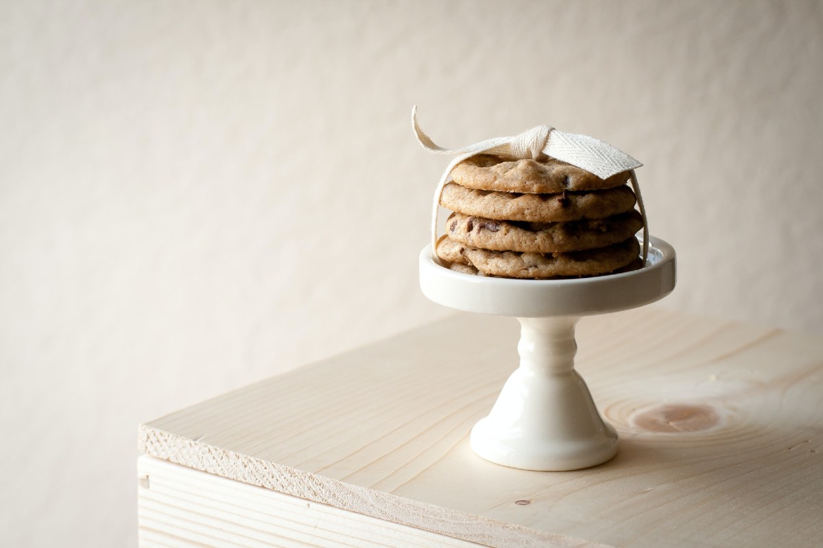 stacked cookies with white ribbon on a saucer