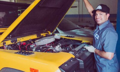 yellow car and man wearing blue uniform