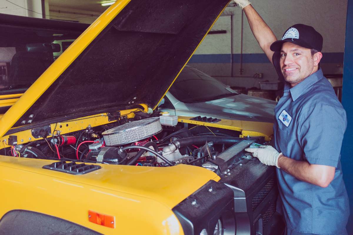 yellow car and man wearing blue uniform