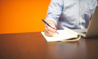 man writing on a piece of paper