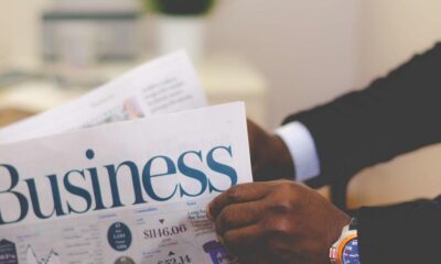 person holding a business newspaper