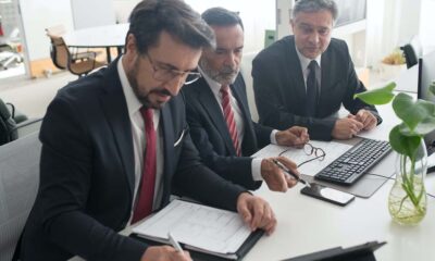 three men in a meeting