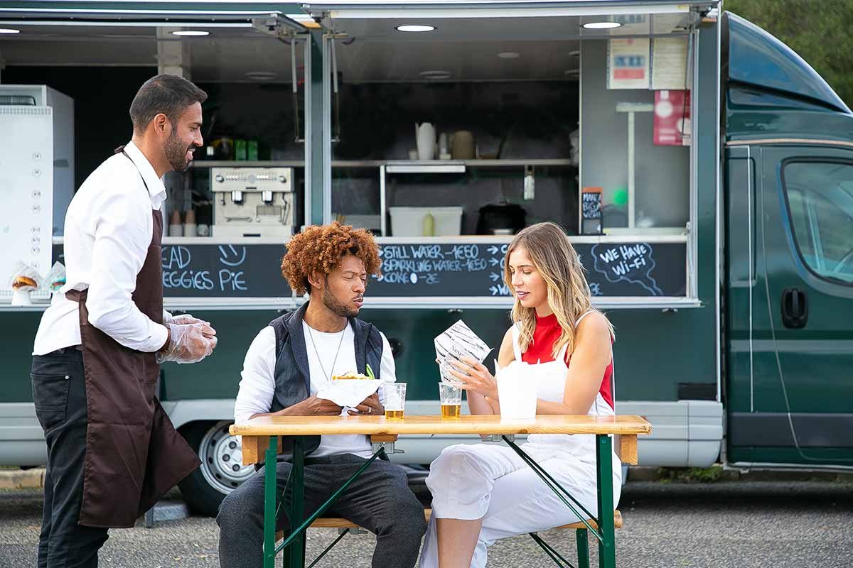 food truck and three people