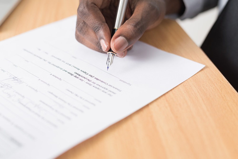 person signing a contract