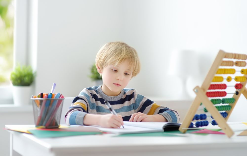 child writing on desk