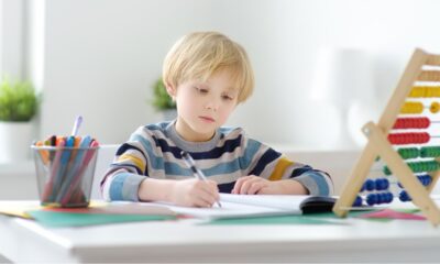 child writing on a desk
