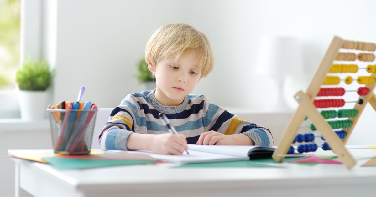 child writing on a desk